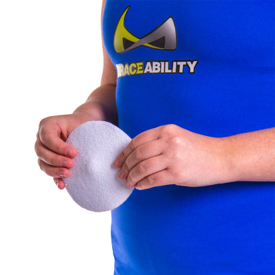 White, circular hernia pad with a raised bump