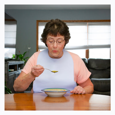 The BraceAbility adult bibs are made of silicone to protect clothes from spills and stains while eating and drinking